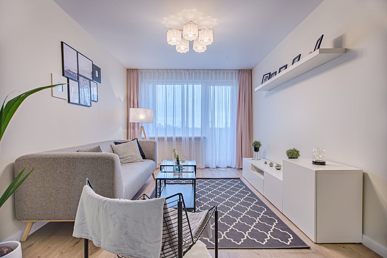 who-we-are Elegant modern living room in Vilnius featuring contemporary furniture and decor.